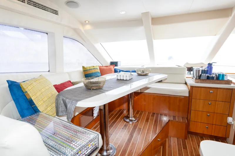 Slide: The Image of Luxurious interior of 2008 Hatteras 64 Motor Yacht with elegant seating and vibrant cushions. - 5
