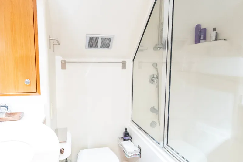 Slide: The Image of Bathroom interior of 2008 Hatteras 64 Motor Yacht with shower and wooden cabinet. - 25