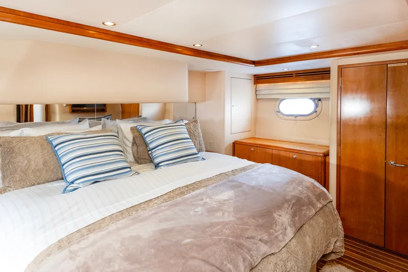 Slide: The Image of Luxurious bedroom interior of 2008 Hatteras 64 Motor Yacht with elegant bedding and wood accents. - 24
