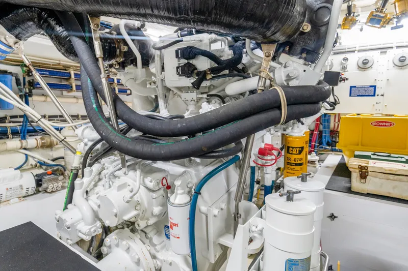 Slide: The Image of Engine room of 2008 Hatteras 64 Motor Yacht with visible hoses and machinery. - 31