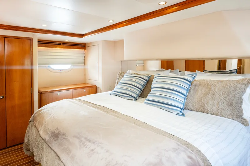 Slide: The Image of Luxurious bedroom interior of 2008 Hatteras 64 Motor Yacht with elegant bedding and wood accents. - 23