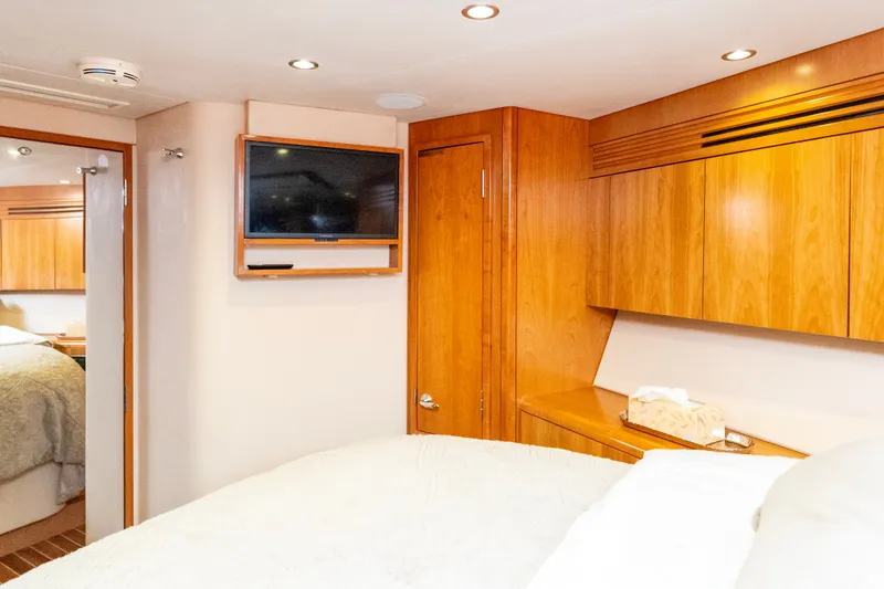 Slide: The Image of Luxurious cabin interior of 2008 Hatteras 64 Motor Yacht with wood paneling and mounted TV. - 21