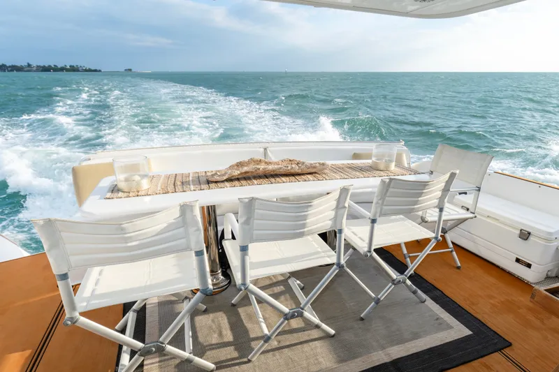 Slide: The Image of Aft deck of 2008 Hatteras 64 Motor Yacht with ocean view and seating area. - 16