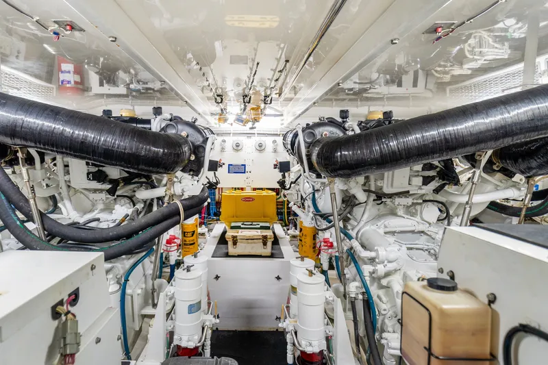 Slide: The Image of Engine room of a 2008 Hatteras 64 Motor Yacht, showcasing dual engines and mechanical systems. - 30