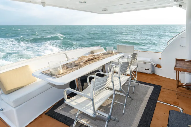 Slide: The Image of Outdoor dining area on 2008 Hatteras 64 Motor Yacht with ocean view. - 11