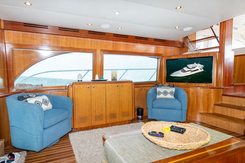 Slide: The Image of Luxurious interior of 2008 Hatteras 64 Motor Yacht with cozy seating and elegant wood finishes. - 4