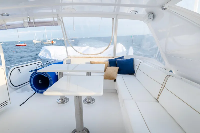 Slide: The Image of Luxurious 2008 Hatteras 64 Motor Yacht interior with white seating and ocean view. - 19