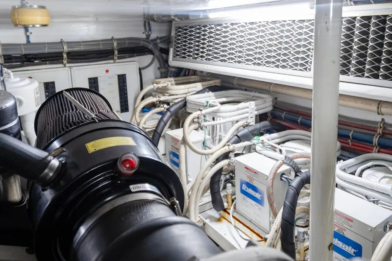 Slide: The Image of Engine room of 2008 Hatteras 64 Motor Yacht with complex piping and machinery. - 27