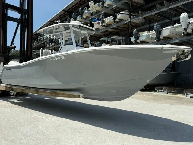 The Image of A 2018 Tidewater 280 CC Adventure boat stored on a rack in a warehouse. - 0