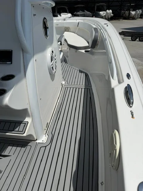 Slide: The Image of The image shows the deck of a 2018 Tidewater 280 CC Adventure boat with gray flooring. - 9