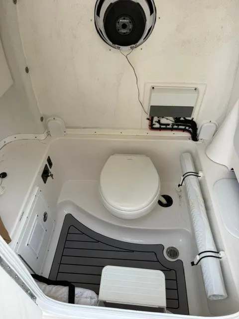 Slide: The Image of Interior of a 2018 Tidewater 280 CC Adventure with a toilet and speaker. - 16
