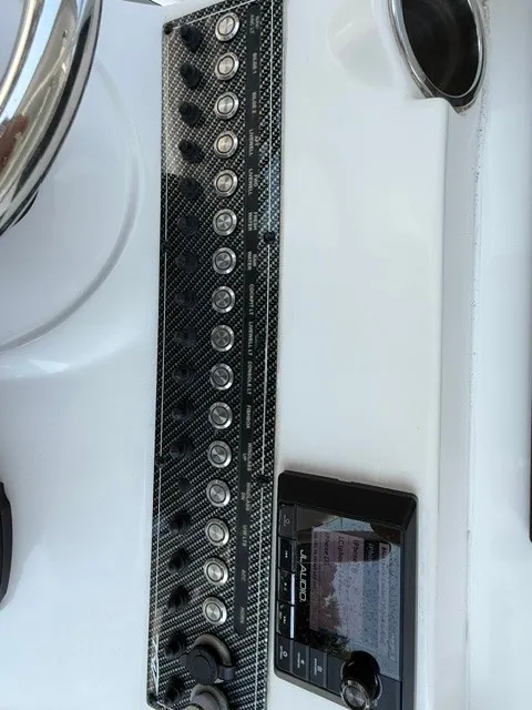 Slide: The Image of Control panel and steering on a 2018 Tidewater 280 CC Adventure boat. - 18