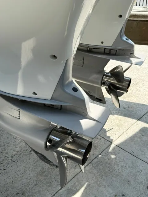 Slide: The Image of Close-up of two outboard motors with shiny propellers. - 25