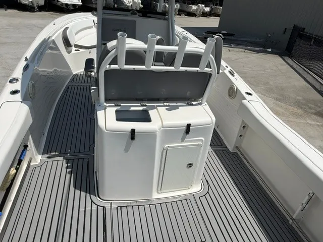Slide: The Image of The image shows the cockpit of a 2018 Tidewater 280 CC Adventure with gray flooring and rod holders. - 6