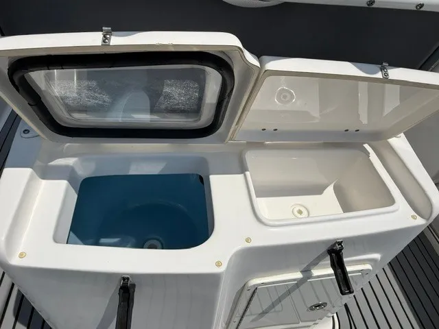 Slide: The Image of Open compartments on a boat with blue and white interiors. - 7