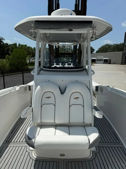 Slide: The Image of The image shows a 2018 Tidewater 280 CC Adventure boat with white seating and a shaded helm. - 13