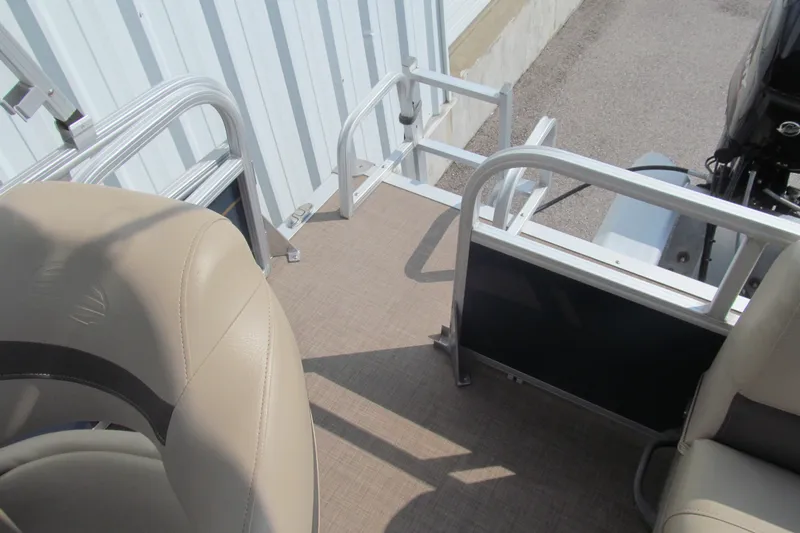 Slide: The Image of 2022 Sun Tracker Bass Buggy 16 XL boat interior with beige seating and railing. - 14