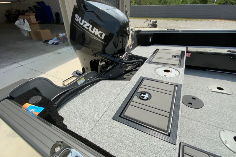 Slide: The Image of 2026 Starcraft Storm 166 DC Pro boat with Suzuki outboard motor in a garage setting. - 9
