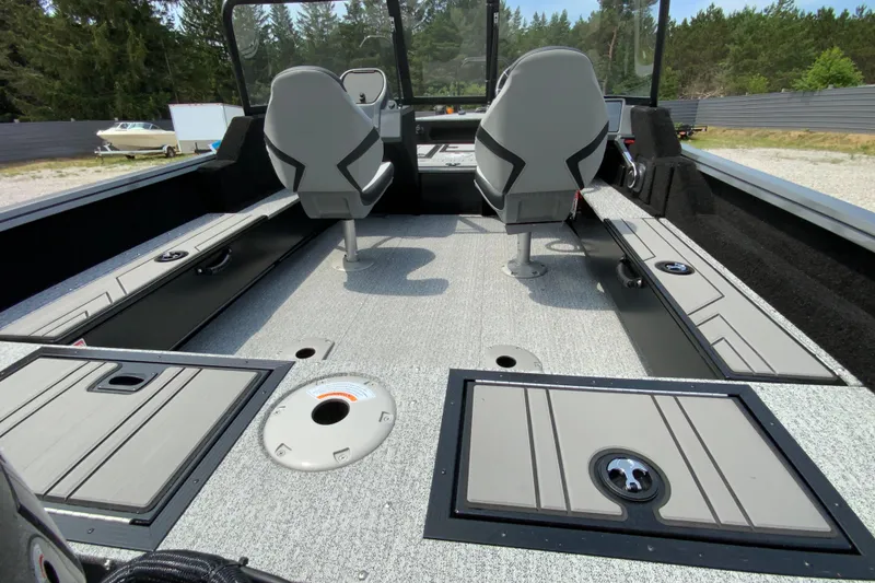 Slide: The Image of 2026 Starcraft Storm 166 DC Pro boat interior with dual seats and storage compartments. - 10