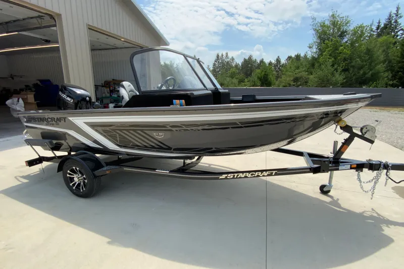 Slide: The Image of 2026 Starcraft Storm 166 DC Pro boat on trailer, parked outdoors. - 4