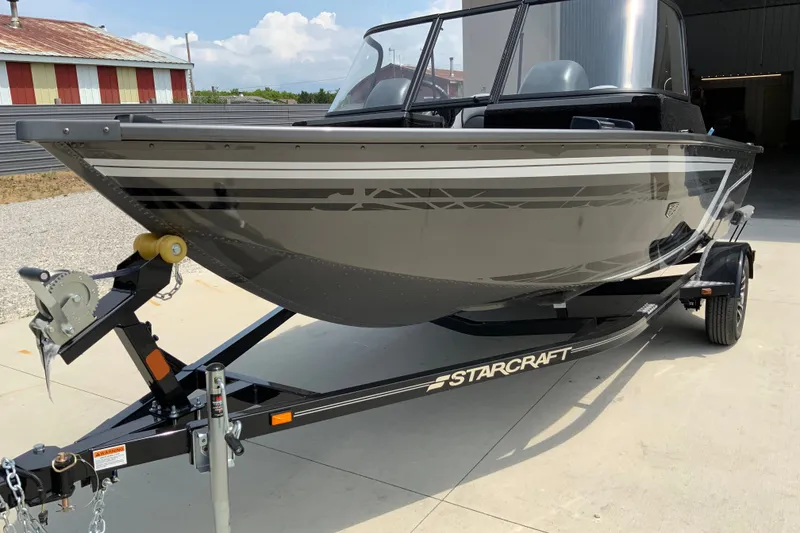 Slide: The Image of 2026 Starcraft Storm 166 DC Pro boat on trailer, parked outdoors. - 3