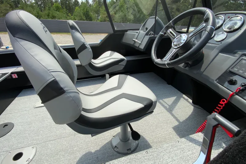 Slide: The Image of Interior of 2026 Starcraft Storm 166 DC Pro boat with modern seating and steering wheel. - 7