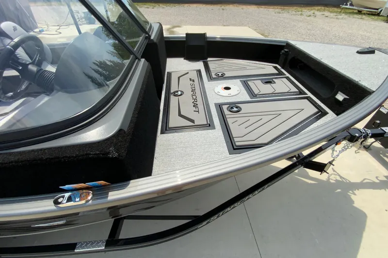 Slide: The Image of 2026 Starcraft Storm 166 DC Pro boat deck with storage compartments and steering wheel. - 5