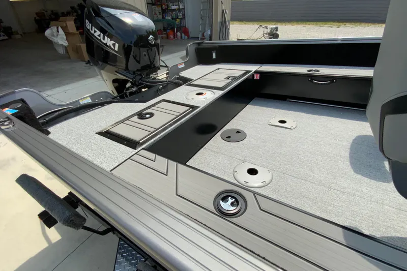 Slide: The Image of 2026 Starcraft Storm 166 DC Pro boat interior with Suzuki motor, featuring storage compartments. - 8