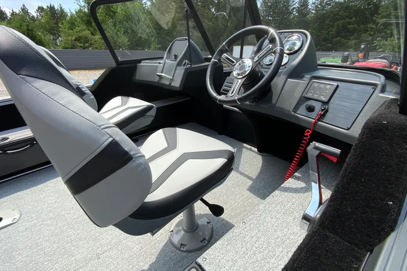 Slide: The Image of Interior of 2026 Starcraft Storm 166 DC Pro boat with modern steering and seating. - 6