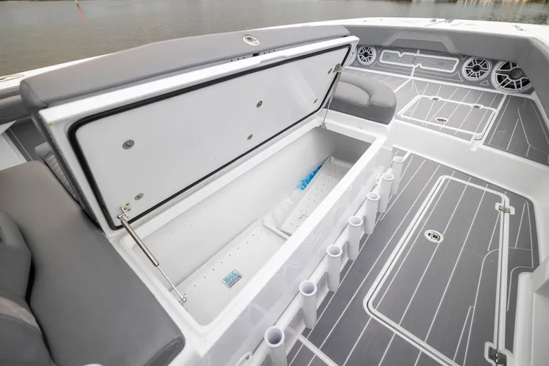 Slide: The Image of Freeman 42LR 2026 boat interior with open storage compartment and rod holders. - 15