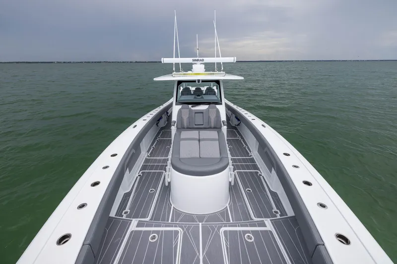 Slide: The Image of 2026 Freeman 42LR boat on calm water, showcasing sleek design and spacious deck. - 19