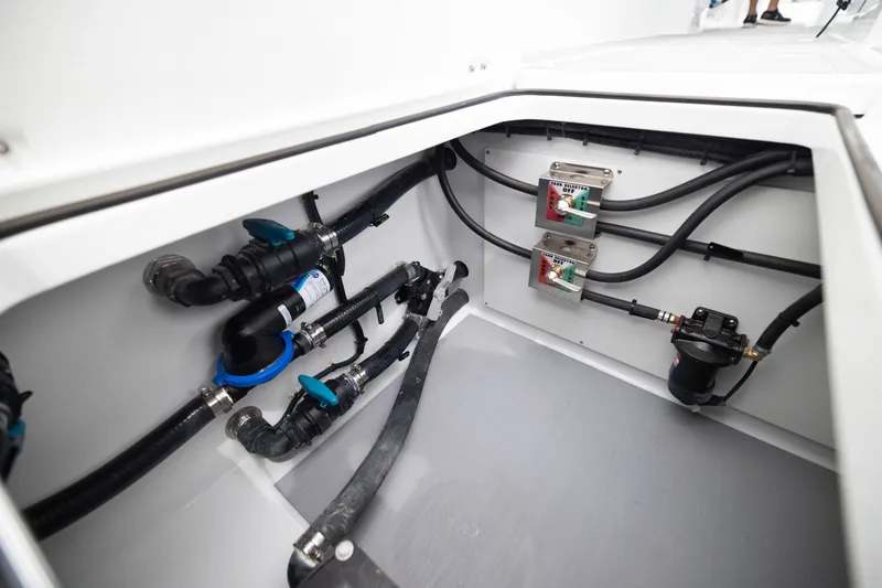 Slide: The Image of Freeman 42LR 2026 boat plumbing system with valves and hoses in compartment. - 56