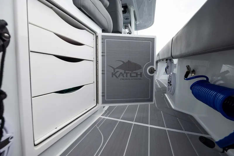 Slide: The Image of Interior view of 2026 Freeman 42LR boat storage compartment with Katch Fishing Apparel logo. - 46