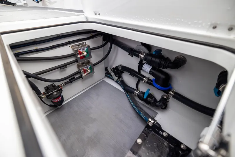 Slide: The Image of Freeman 42LR 2026 boat plumbing system with valves and hoses in storage compartment. - 57