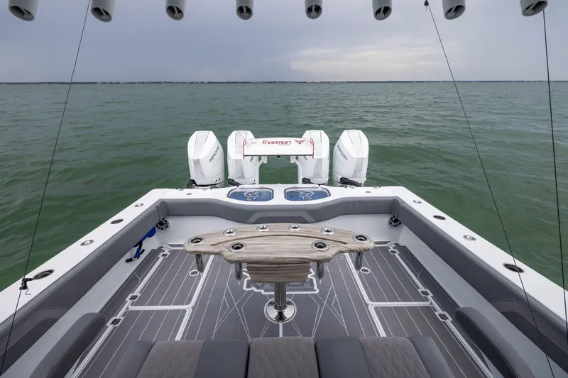 Slide: The Image of Sleek 2026 Freeman 42LR boat with dual engines on open water. - 48