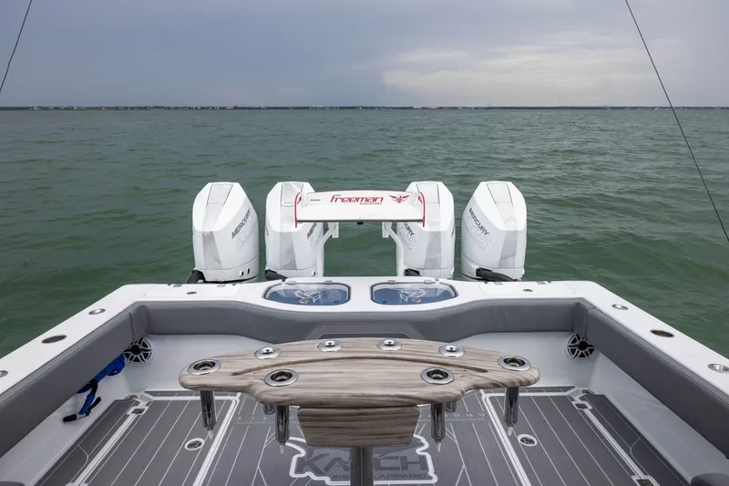 Slide: The Image of Freeman 42LR 2026 boat with triple Mercury engines on open water. - 51
