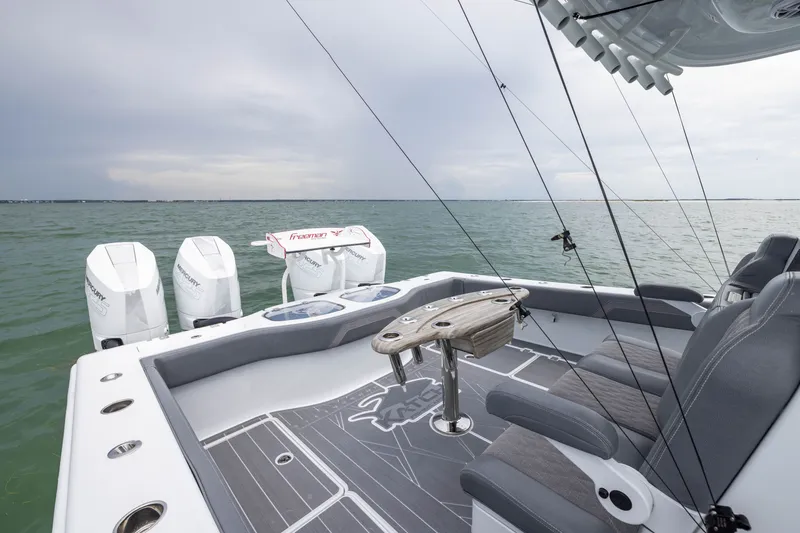 Slide: The Image of 2026 Freeman 42LR boat with Mercury engines, featuring a sleek deck and comfortable seating. - 49