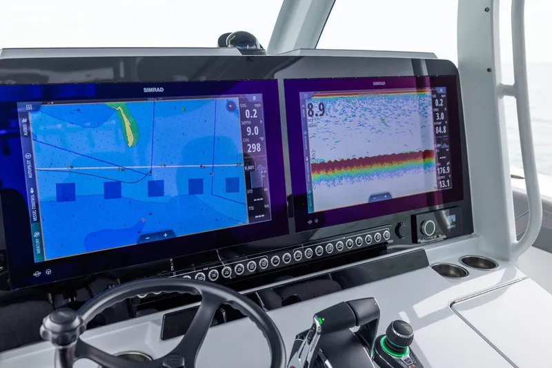 Slide: The Image of Dual navigation screens on a 2026 Freeman 42LR boat dashboard. - 36