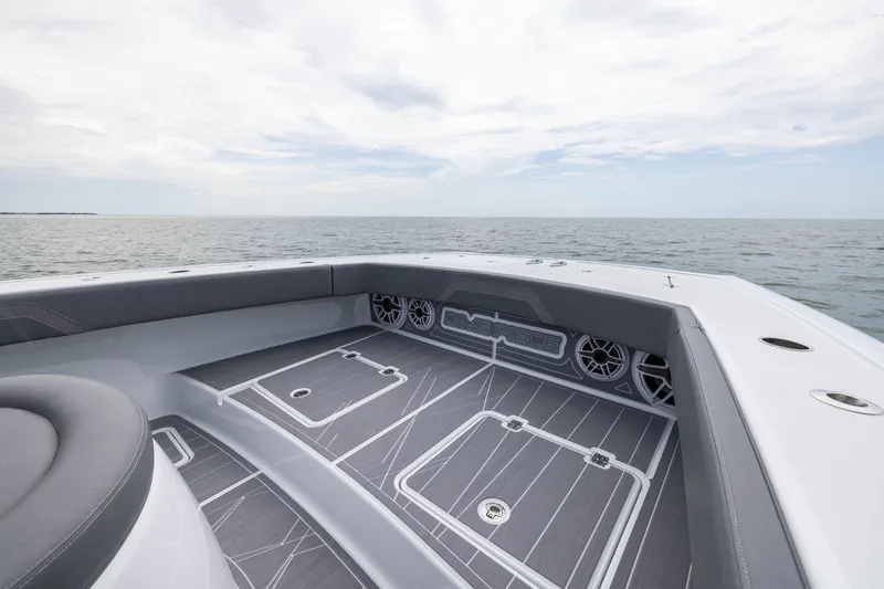 Slide: The Image of 2026 Freeman 42LR boat deck with sleek design, overlooking calm ocean waters. - 14