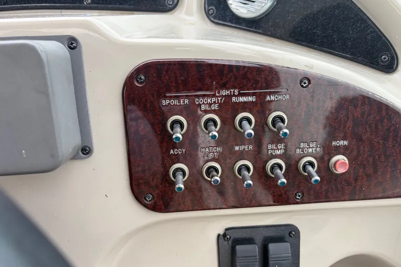 Slide: The Image of Control panel of a 2005 Sea Ray Sundancer 260 boat with various switches. - 18