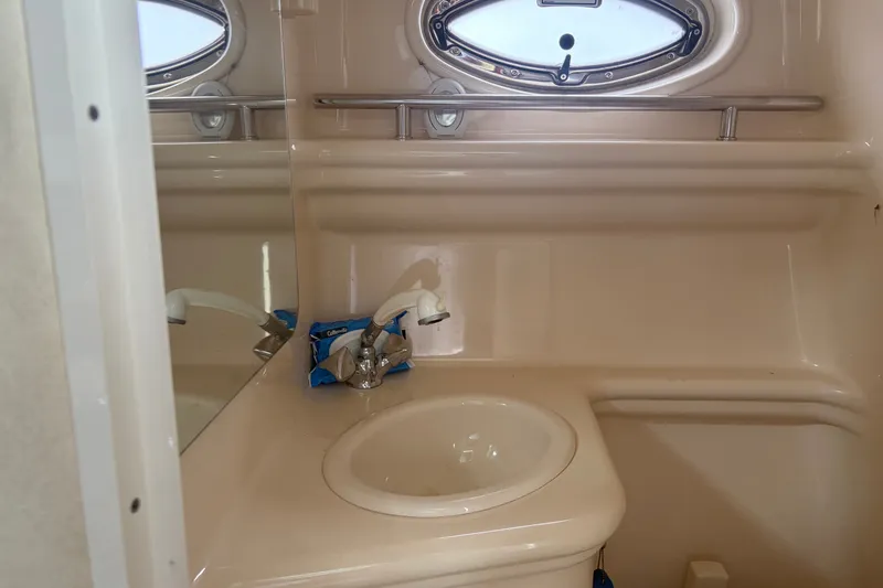 Slide: The Image of 2005 Sea Ray Sundancer 260 bathroom with sink, faucet, and oval window. - 27