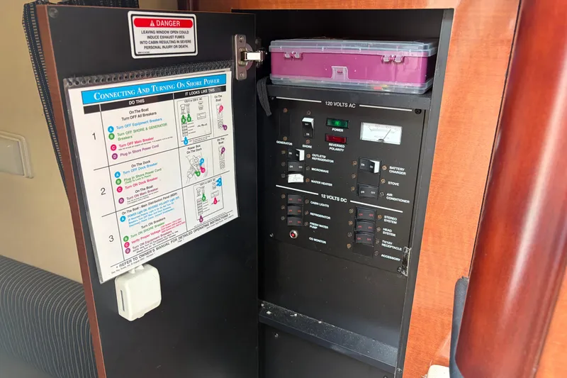 Slide: The Image of Electrical panel of a 2005 Sea Ray Sundancer 260 boat with shore power instructions. - 30