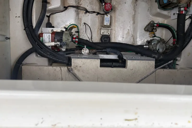 Slide: The Image of Engine compartment of a 2005 Sea Ray Sundancer 260 boat, showing hoses and components. - 36