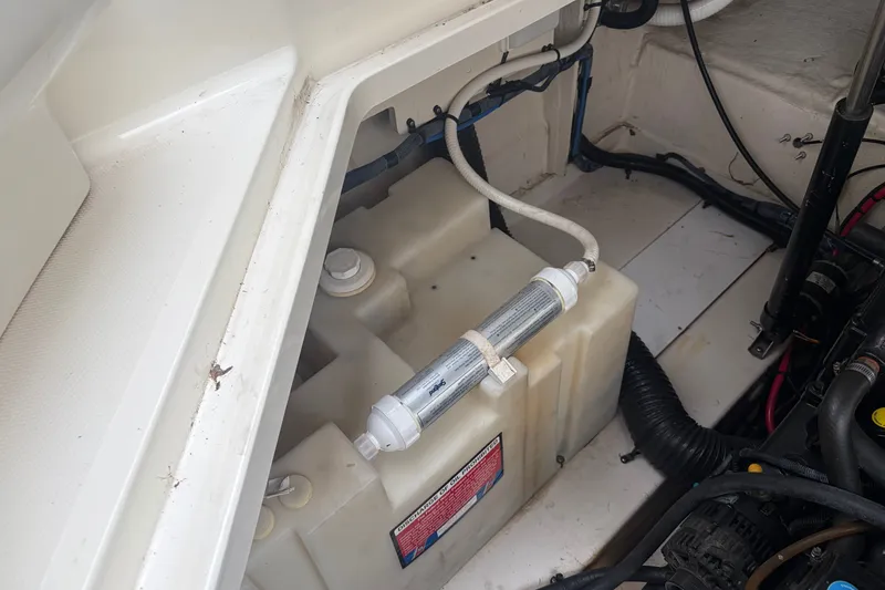 Slide: The Image of Engine compartment of 2005 Sea Ray Sundancer 260 showing water tank and filter system. - 33