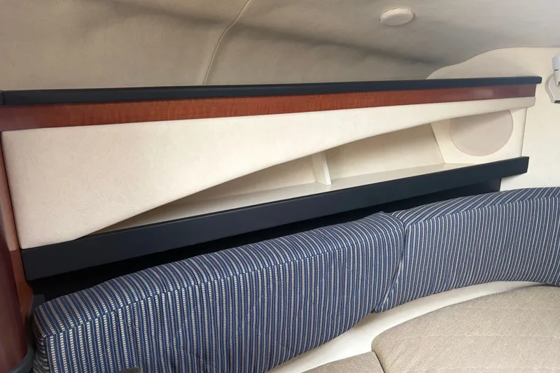 Slide: The Image of Interior cabin of 2005 Sea Ray Sundancer 260 with striped upholstery and wooden accents. - 22