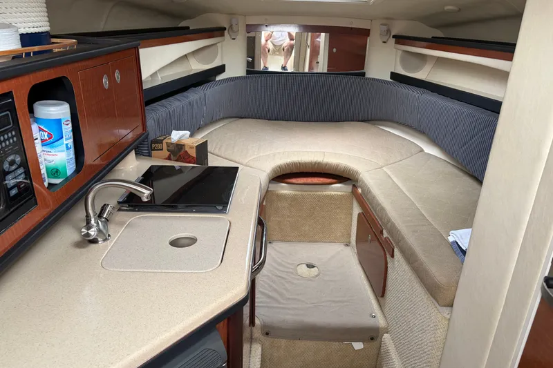Slide: The Image of Interior of 2005 Sea Ray Sundancer 260 boat with kitchenette and seating area. - 20