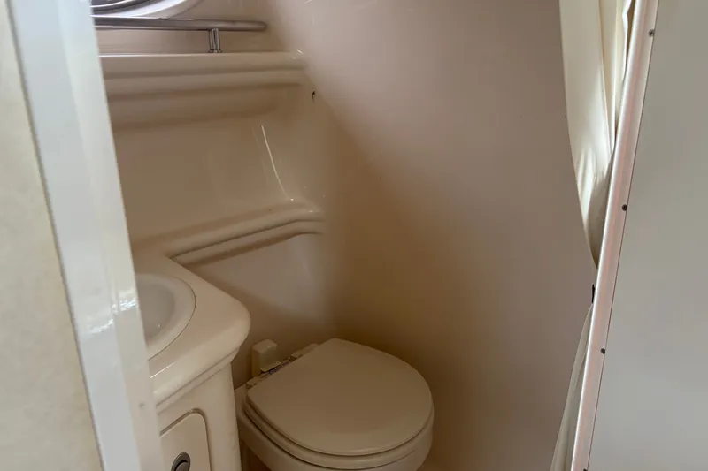 Slide: The Image of 2005 Sea Ray Sundancer 260 boat bathroom with compact toilet and sink. - 26