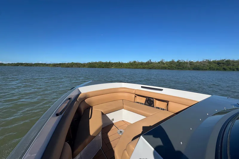 Slide: The Image of 2022 Aviara AV40 OB boat with tan seating on a calm lake under clear blue skies. - 20