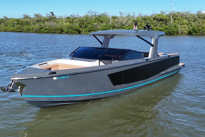 Slide: The Image of 2022 Aviara AV40 OB luxury boat on calm water, sleek design, modern features. - 9
