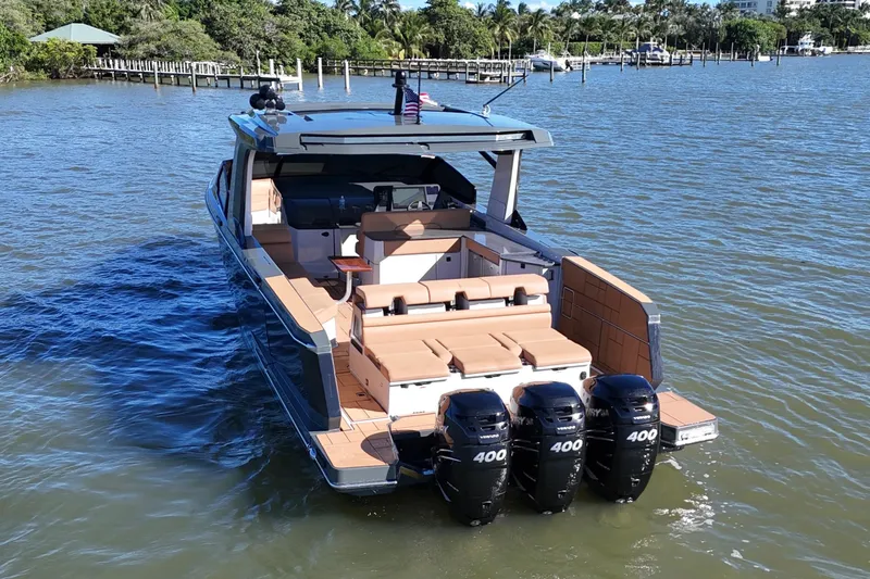 Slide: The Image of 2022 Aviara AV40 OB boat with triple Mercury 400 engines on a calm waterway. - 4